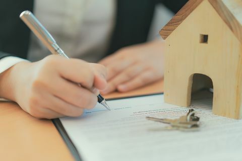 Концептни уговор о куповини куће, пословна жена потписује уговор о куповини куће.